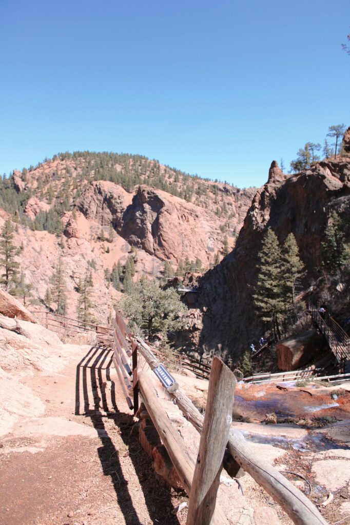 Image of rocky trail with wooden fence in this historic colorado springs site
